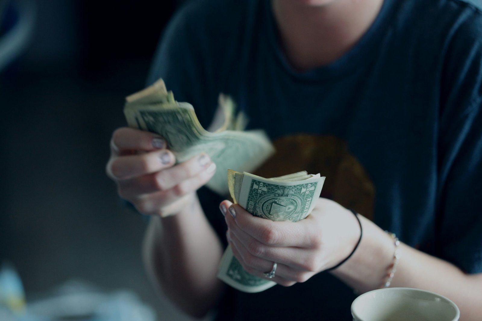 person counting dollar banknotes